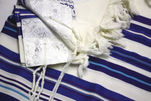 Before putting on a tallit, it is a customary tradition to kiss it and 